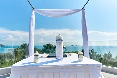 The wedding arch, altar setup with white table, Candles on the table Stock Photos
