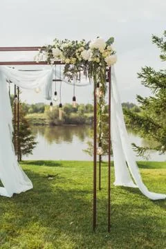 Wedding arch decorated with flowers on a wedding ceremony. Soft day light Stock Photos