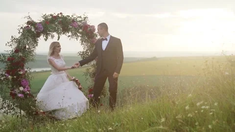 Wedding arch on the edge of a cliff on the background of the river Stock Footage 233712474