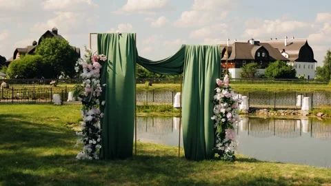 The wedding arch is located on the shore of the pond Stock Footage 338347292