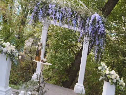 Wedding arch with purple and white flowers in a summer park Stock Footage 123720023