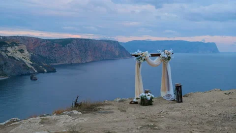 The wedding arch stands on the edge of the mountain. Video stock 98038196