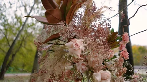 Wedding arch of white and brown roses outdoors in the forest in nature Stock Footage 304083290
