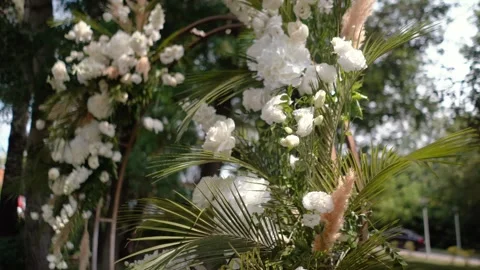 Wedding arch of white rose flowers the wedding ceremony of the bride and groom Stock Footage 282910226