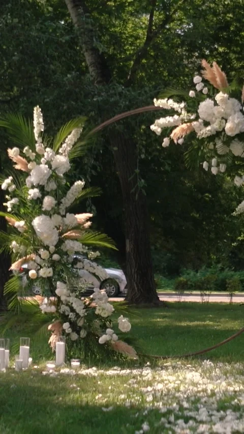 Wedding arch of white rose flowers the wedding ceremony of the bride and groom Stock Footage 282912250