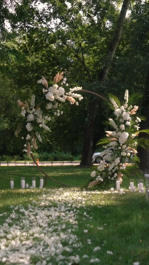 Wedding arch of white rose flowers the wedding ceremony of the bride and groom Stock Footage 282912290