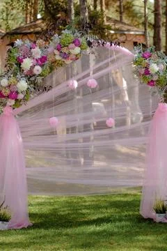 Wedding archway with flowers arranged in park for a wedding ceremony Stock Photos