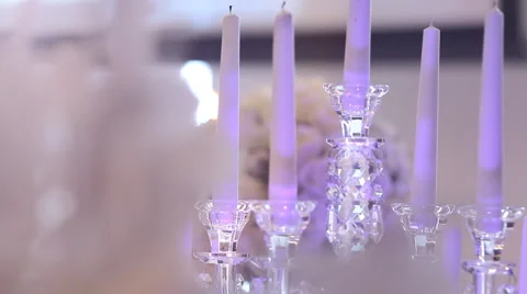 Wedding background. Candles on crystal candlesticks and bouquets of flowers. Stock Footage 62378914