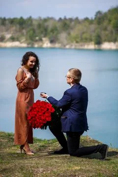 Wedding background in the forest: a man made a surprise, a ring gives a beaut Stock Photos