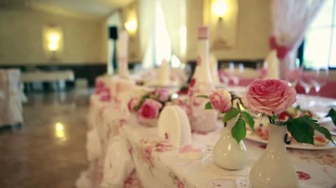 Wedding. Banquet. The chairs and table for guests, decorated with candles Stock Footage 65175469