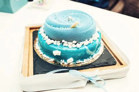 Wedding blue cake with mini balls on a desk Stock Photos