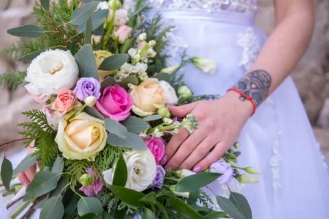 Wedding bouquet and bride's hand Stock Photos