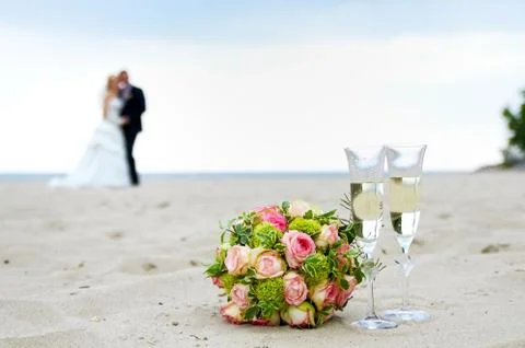 The wedding bouquet with a couple on the beach Stock Photos