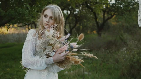 Wedding bouquet in the hands of a beautiful bride, the bride is holding a Stock Footage 150339220