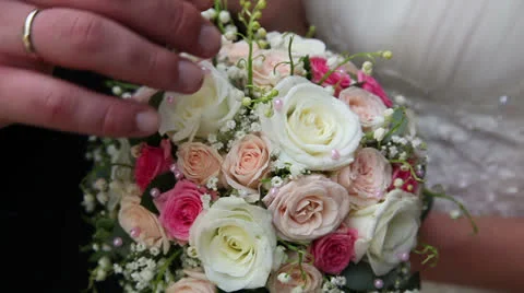 Wedding bouquet in hands of the bride and groom Stock Footage