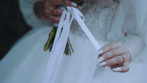 Wedding bouquet in the hands of the bride Stock Footage 164990872