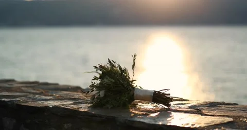 Wedding Bouquet left on a stone wall. In the background stretches a lake in whic Video stock 207862777