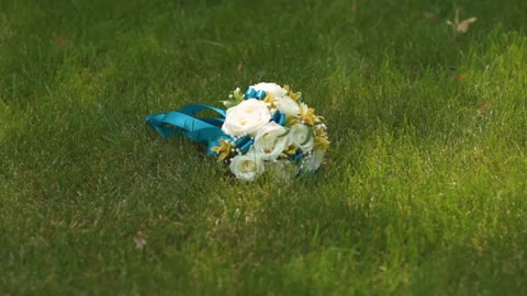 The wedding bouquet is lying on the grass Stock Footage 167467630