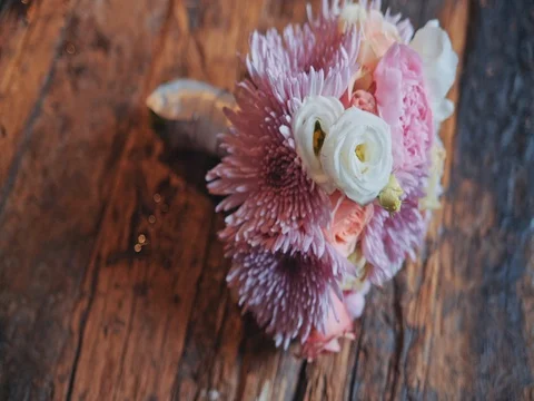 Wedding bouquet lying on a wooden surface 스톡 동영상 75559385