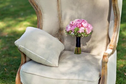 Wedding bouquet of peonies, on a beautiful chair Фото