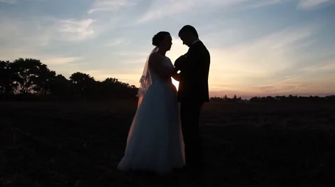 Wedding, bride and groom standing at sunset Stock Footage 54726876