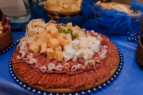 Wedding buffet. Slicing different types of cheese. Catering Stock Photos
