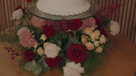 Wedding cake base decorated with vibrant rose arrangement 動画素材 321896923