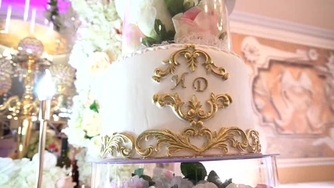 Wedding cake beautiful white multiple floors beautifully decorated with init Stock Footage 150511825