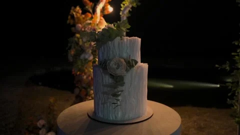 Wedding cake beautifully decorated on a beautiful background, slow motion camera Stock Footage 328314845