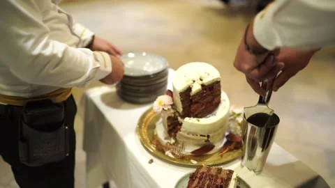 Wedding cake celebration. Intimate indoor moment of cake slicing and celebration Stock Footage 343174604