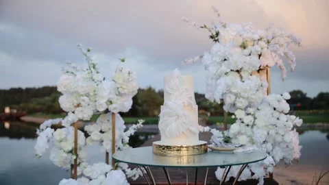 Wedding cake in the ceremonial zone. White wedding cake with creative decor Stock Footage 235470657