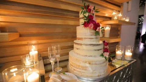 Wedding cake decorated with red flowers Stock-Footage 106209965