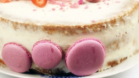 Wedding cake decorated with strawberry, macaroons and lilac flowers 4K slow mo Stock Footage 99491876