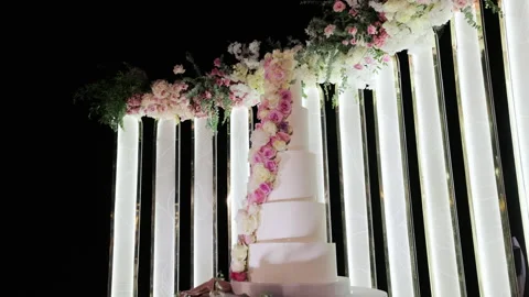 Wedding cake with flowers on the table. White fruit wedding cake on a wedding Stock Footage 196006658