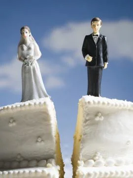 Wedding cake visual metaphor with figurine cake toppers Stock Photos