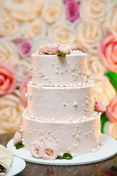 The wedding cake. White cake decorated with roses. Stock Photos