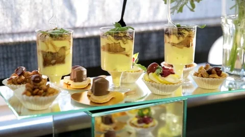 Wedding candy bar decoration setup with delicious cakes and sweets. Stock Footage 97113473
