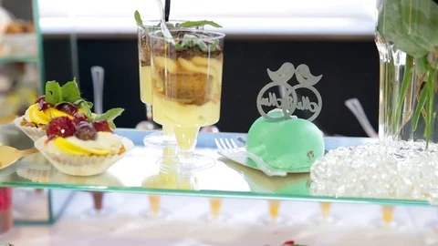 Wedding candy bar decoration setup with delicious cakes and sweets. Stock Footage 97115103