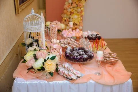 Wedding candy bar, table with sweets decoration setup with delicious cakes and Stock Photos