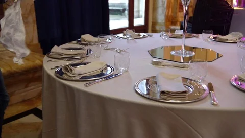 Wedding catering preparation, a waiter preparing a beautiful table set.. Stock-Footage 75601647