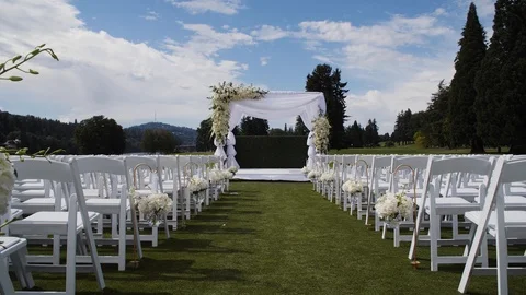 Wedding ceremony set up on grass against a blue sky with clouds 스톡 동영상 104519973
