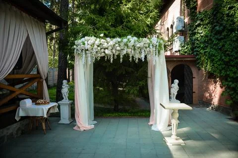 Wedding ceremony. wedding arch, decorated with various fresh flowers Stock Photos
