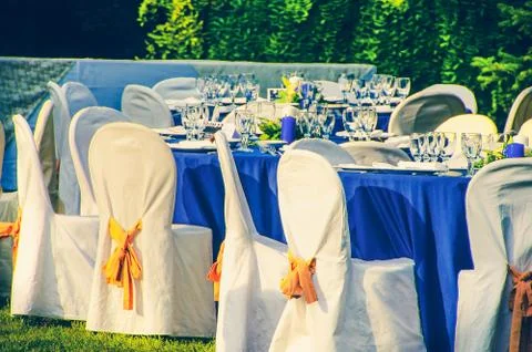 Wedding chairs catering table background in garden Stock Photos