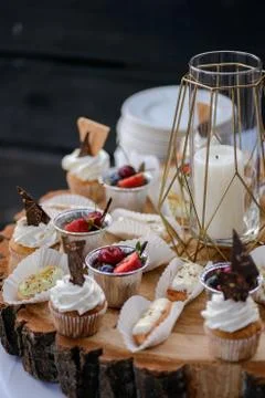 The wedding composition of delicious sponge fruit cakes decorated with juicy che Stock Photos