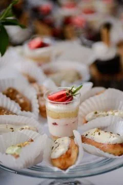 The wedding composition of delicious sponge fruit cakes decorated with juicy che Stock Photos