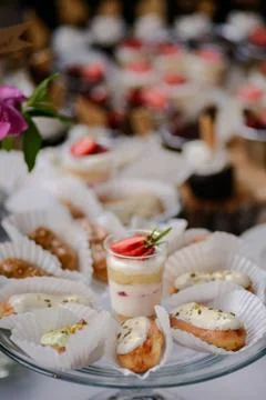 The wedding composition of delicious sponge fruit cakes decorated with juicy che Stock Photos
