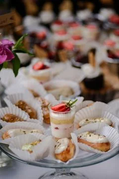 The wedding composition of delicious sponge fruit cakes decorated with juicy che Stock Photos