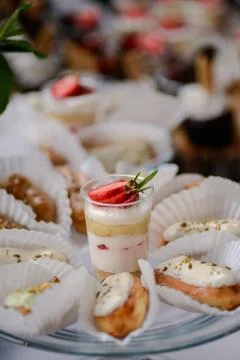 The wedding composition of delicious sponge fruit cakes decorated with juicy che Stock Photos