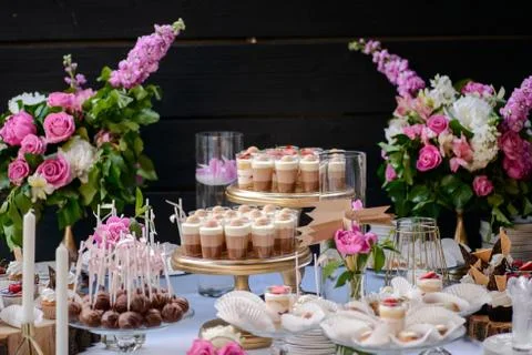 The wedding composition of delicious sponge fruit cakes decorated with juicy che Stock Photos