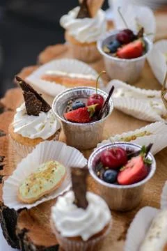 The wedding composition of delicious sponge fruit cakes decorated with juicy che Stock Photos